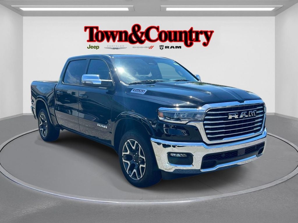 2026 RAM 1500 Laramie Crew Cab 4x4 5'7' Box in Diamond Black Crystal Pearlcoat — front three-quarter view